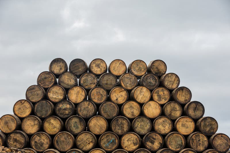 Stacked pile of old wooden barrels and casks at Speyside Cooperage in Scotland