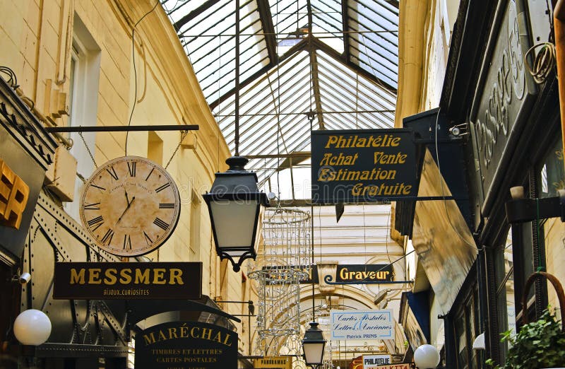 Passage des Panoramas is one of the beautiful glass-covered passages built to protect wealthy shoppers from the rain in Paris, France. Built in 1799, it is the oldest of such passageways and the first public place lit by gaslight in 1817. Many shops and restaurants are located in the passage, frequented by locals and tourists. Passage des Panoramas is one of the beautiful glass-covered passages built to protect wealthy shoppers from the rain in Paris, France. Built in 1799, it is the oldest of such passageways and the first public place lit by gaslight in 1817. Many shops and restaurants are located in the passage, frequented by locals and tourists.