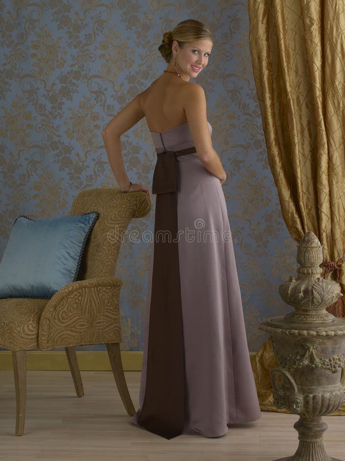 Beautiful blond fashion model wearing light purple evening gown in fancy room setting. Beautiful blond fashion model wearing light purple evening gown in fancy room setting.
