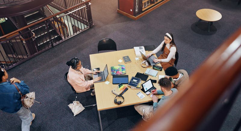 Above, laptop and studying of group, library and browsing of web, education and friends with technology. College royalty free stock image
