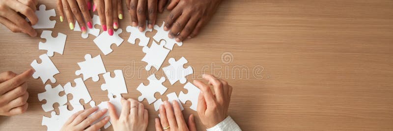 Above panoramic view hands of diverse people assembling jigsaw puzzle royalty free stock images Above panoramic view hands of diverse people assembling jigsaw puzzle royalty free stock images