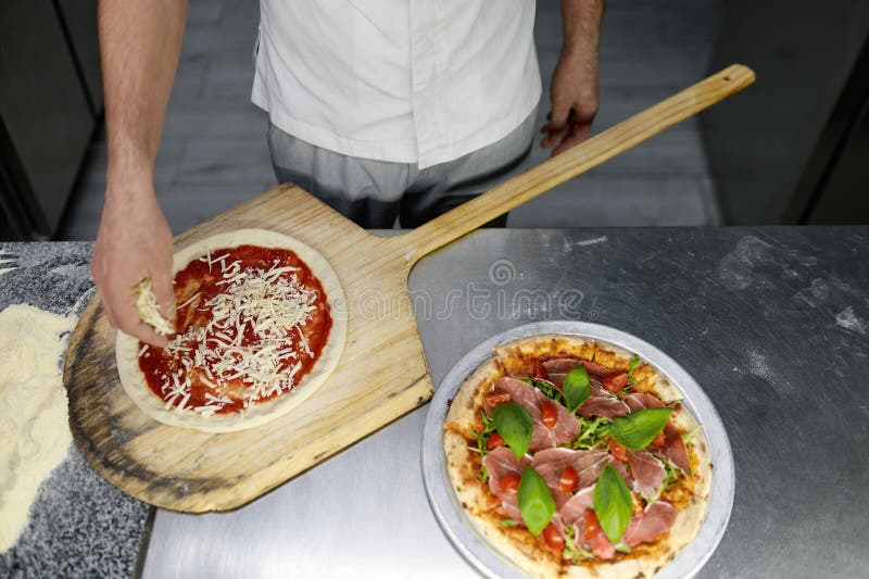 Above View on Chef Hand Preparing Pizza Base on Professional Kitchen