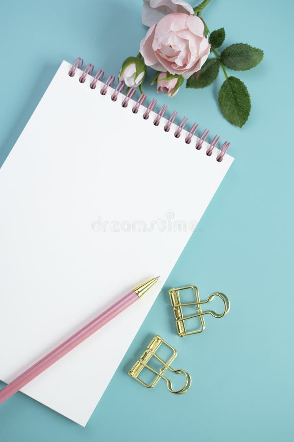 Notebook and stationery on blue background. royalty free stock photography