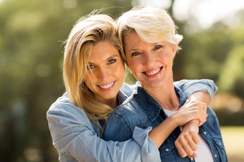 Close up portrait of mother and daughter hugging. Close up portrait of mother and daughter hugging