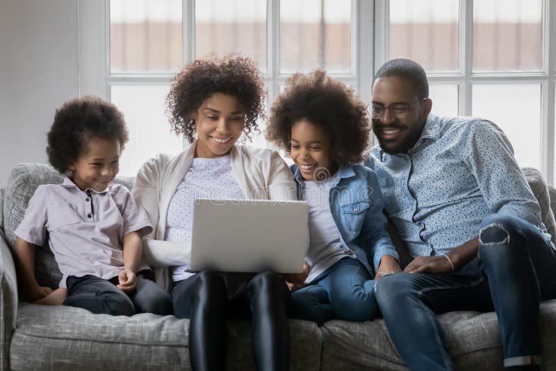 Abschluss in glückliche Afroamerikanerfamilie mit Kindern mithilfe des Notebooks lizenzfreie stockfotografie