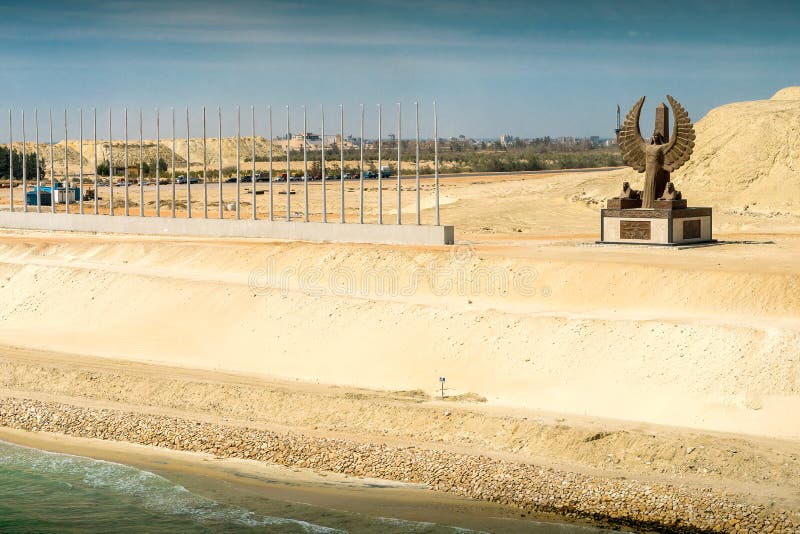 Sinai, Egypt - April 2nd, 2016: Section of the Suez Canal`s expansion canal, opened in August 2015, with the al-Sisi monument. Sinai, Egypt - April 2nd, 2016: Section of the Suez Canal`s expansion canal, opened in August 2015, with the al-Sisi monument