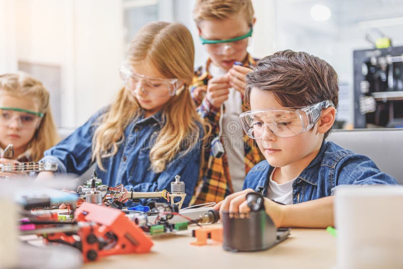 Absorbedly working children in workshop