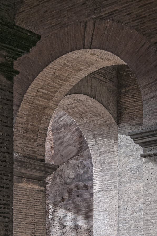 A close up view of some of the many arches that make up the impressive colosseum ruin in Rome, Italy. A close up view of some of the many arches that make up the impressive colosseum ruin in Rome, Italy.