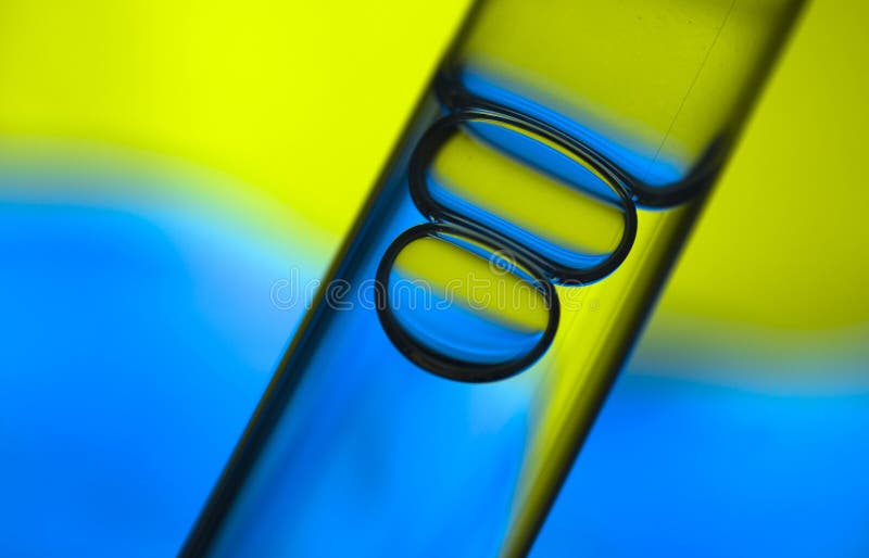 Macro picture of bubbles in test-tube on blue background. Macro picture of bubbles in test-tube on blue background