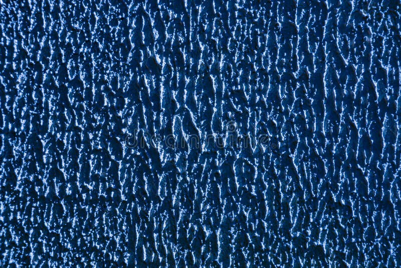 Abstract background of blue embossed rough plaster. stock photography