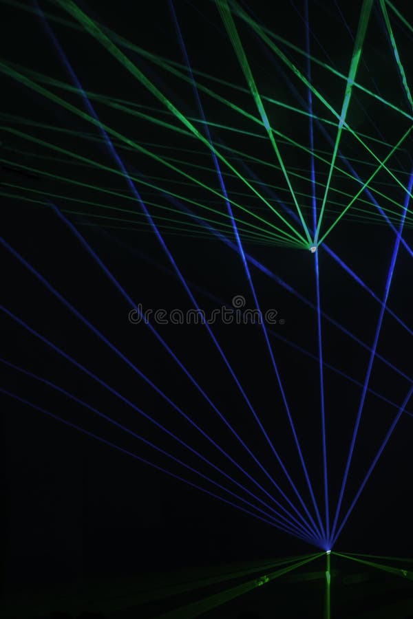 Abstract background with blurred ray of light. Lighting and spotlights lines, stage light and smoke. Disco laser with beams through smoke. Abstract background with blurred ray of light. Lighting and spotlights lines, stage light and smoke. Disco laser with beams through smoke.