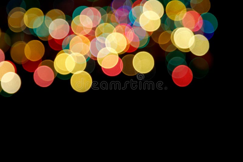 Abstract background with bright round bokeh on a black background for New Year`s design. Blur Close-up stock image