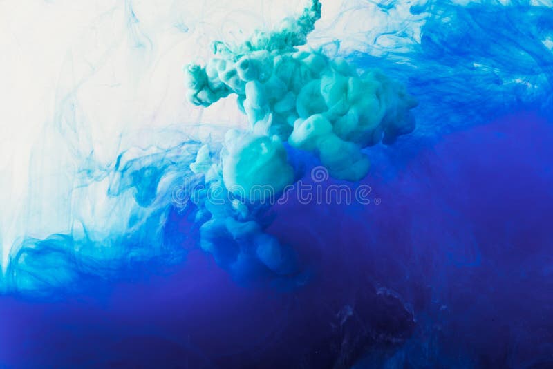 Abstract background with flowing blue and turquoise ink in water royalty free stock photos
