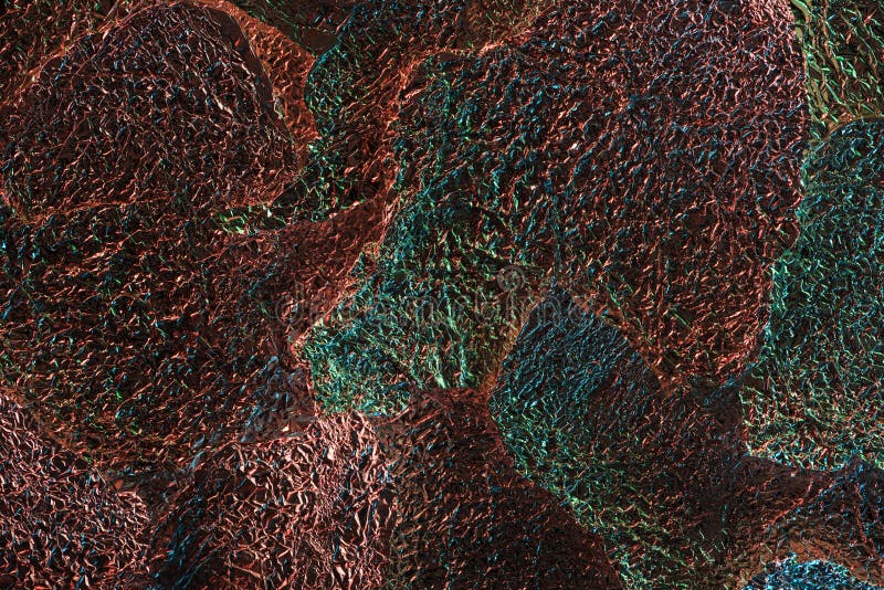 Abstract background of glossy silver textured ragged foil with colorful illumination. stock photography