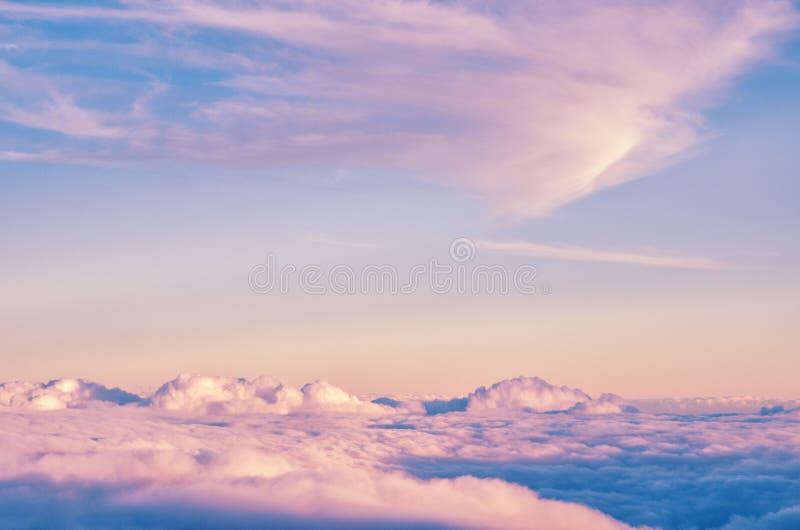 Abstract background with pink, purple and blue colors clouds. Sunset sky above the clouds.