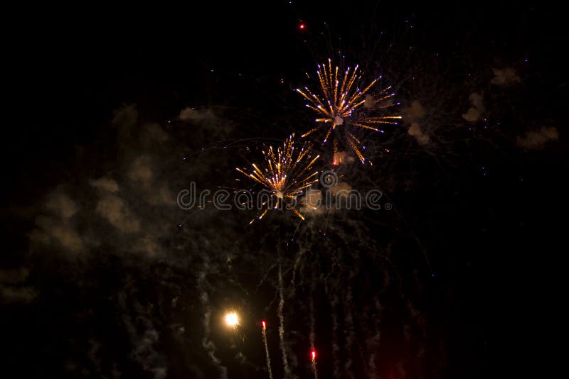 Abstract Background: Rising and Exploding Orange and Purple Fireworks with Smoke stock image