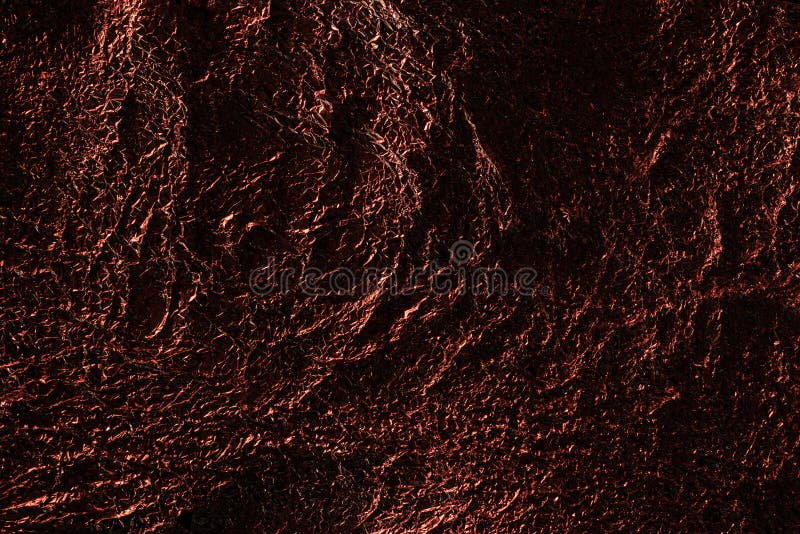 Abstract background of silver textured crumpled foil with red lighting. royalty free stock images