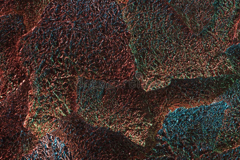 Abstract background of silver textured ragged foil with colorful illumination. stock photo