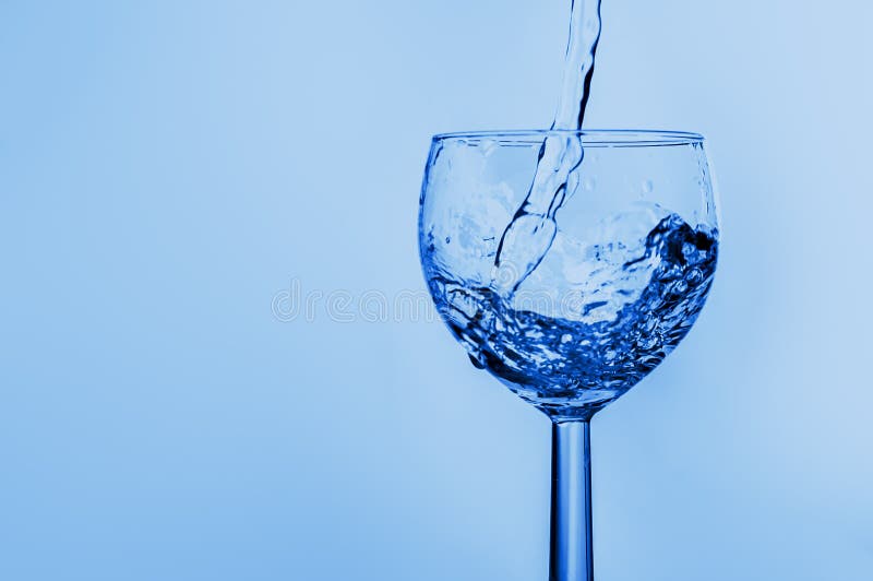 Abstract Background with a Wine Glass in Which Water is Poured Stock