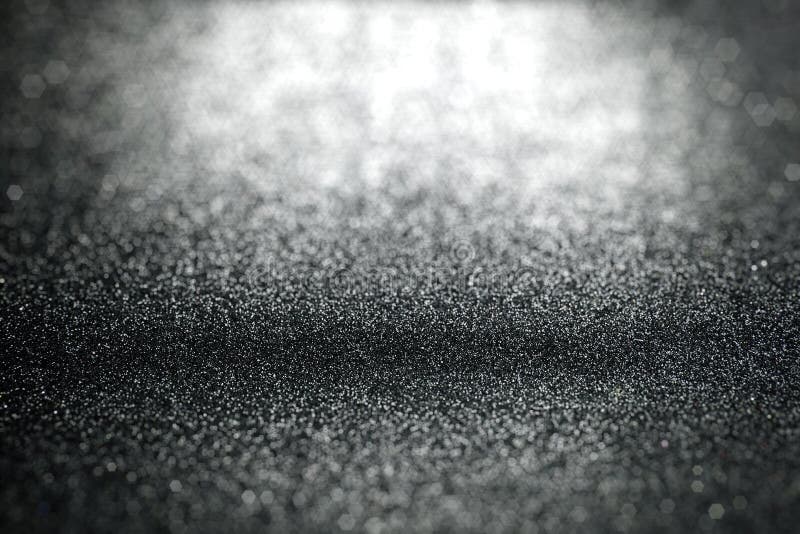 Abstract black glitter lights background with surface texture focused royalty free stock photo Abstract black glitter lights background with surface texture focused royalty free stock photo