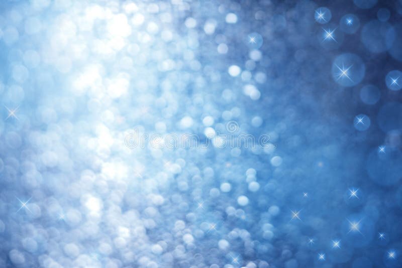 An abstract blue background with sparkle lights and stars. An abstract blue background with sparkle lights and stars