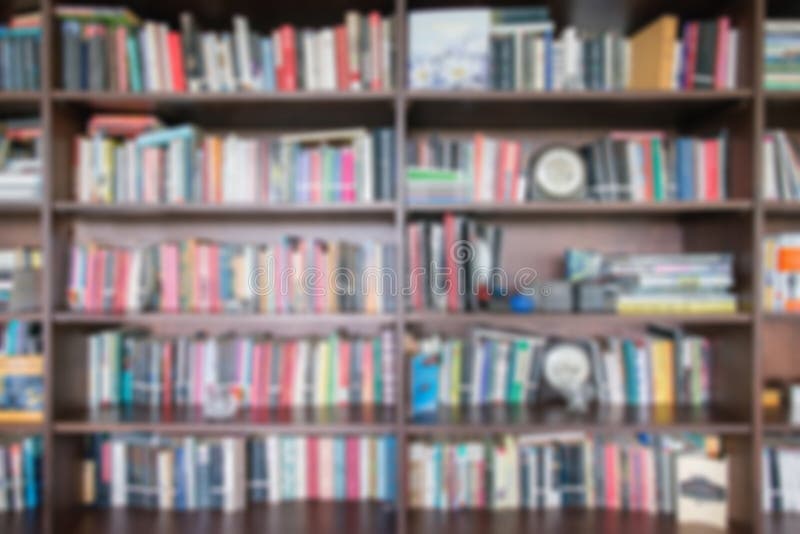 Abstract Blur And Defocused Bookshelf In Library Interior For Background.vintage Bookshelf With Many Books For Education In