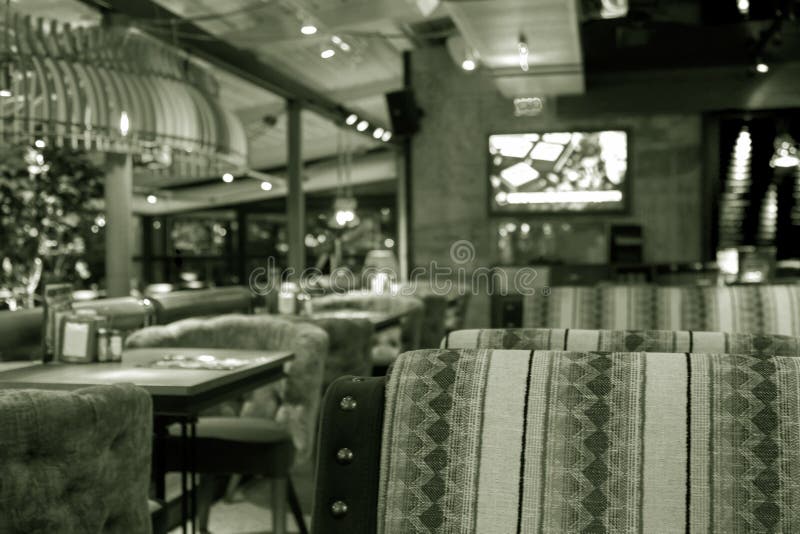 Abstract blurred background of evening cafe, restaurant, pub in warm evening colors. Abstract unsharp background of interior of royalty free stock photography