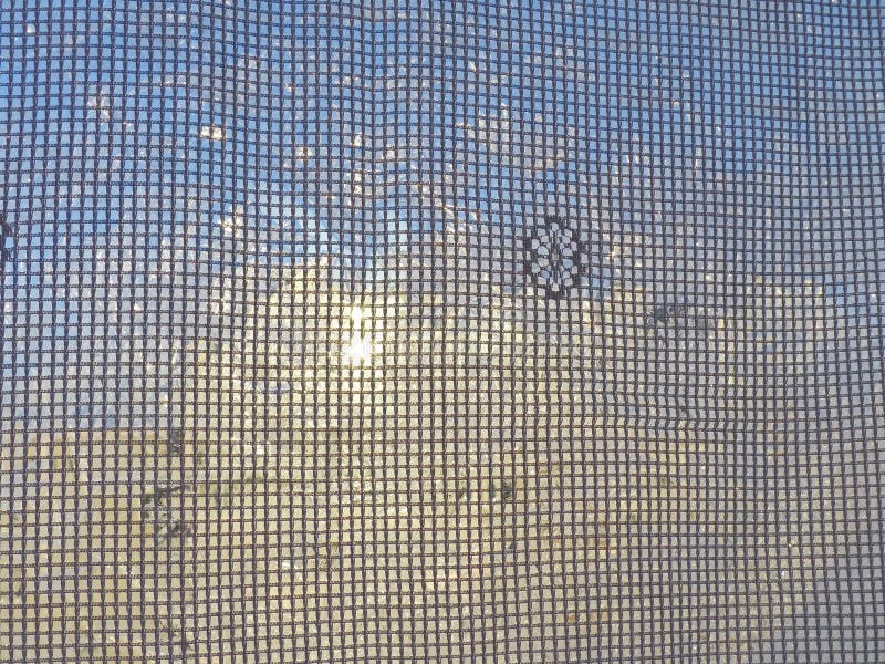Abstract blurred background of frosty window and thin curtains on it. Ideas for creativity and text. Frosty patterns on the window stock image Abstract blurred background of frosty window and thin curtains on it. Ideas for creativity and text. Frosty patterns on the window stock image