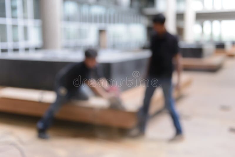 Abstract blurred image of carpenters use circular saw to cut the wood stock image