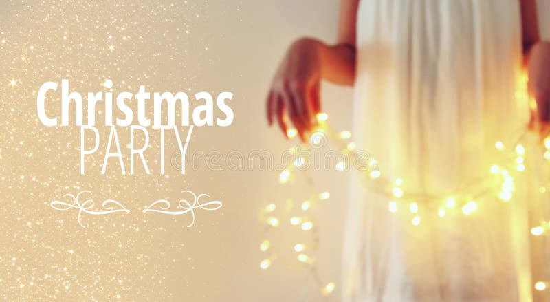 Abstract and bokeh image of young woman holding garland christmas lights and typography: CHRISTMAS PARTY. Holiday invitation conce. Pt royalty free stock photos Abstract and bokeh image of young woman holding garland christmas lights and typography: CHRISTMAS PARTY. Holiday invitation conce. Pt royalty free stock photos