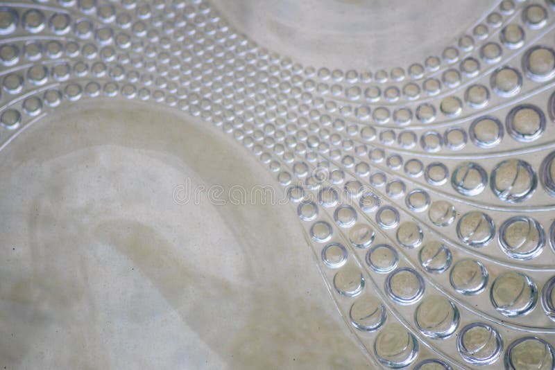 Abstract circle pattern in a glass brick as glass background shows a symmetric and elegant design in transparency like waves