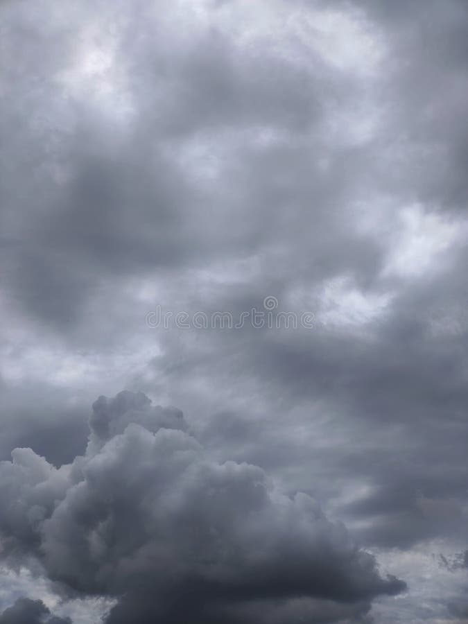 Abstract cloudscape featuring a variety of gray tones and textures, reminiscent of an approaching storm.