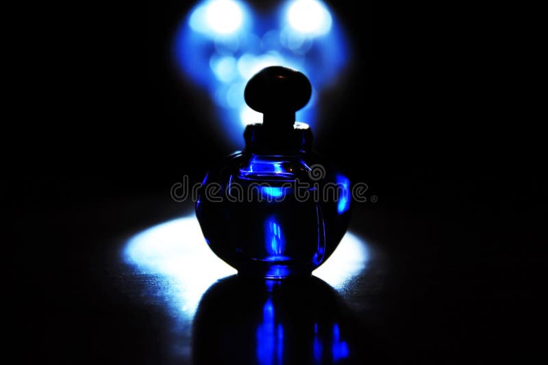 Abstract color midnight blue luxury French perfume bottle black background