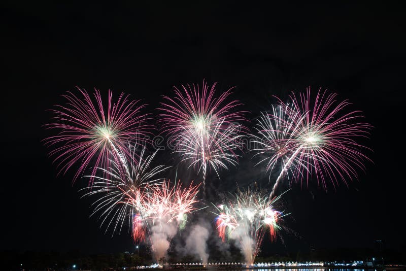 Colored Firework Lights in the Night Sky with Buildings Background