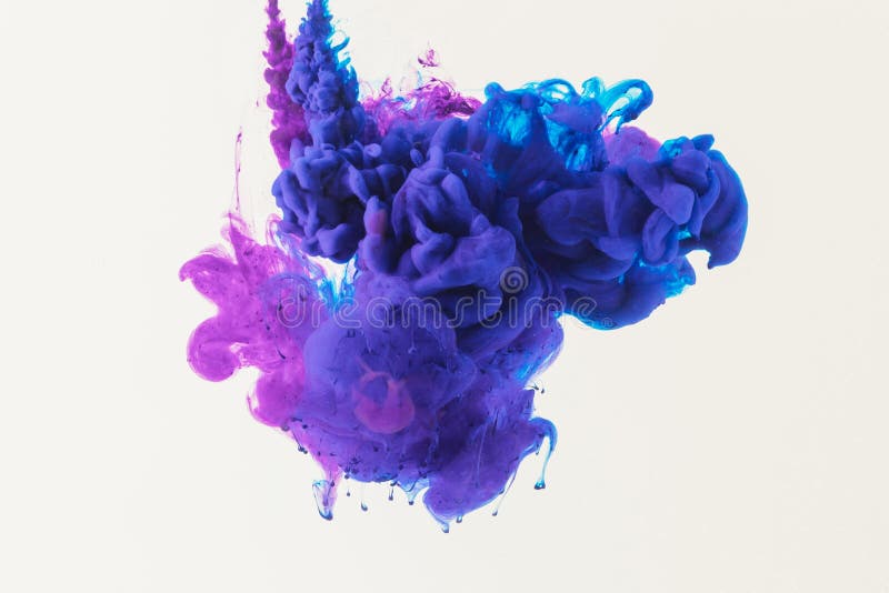 Abstract design with flowing blue and purple ink in water, isolated on white royalty free stock photo