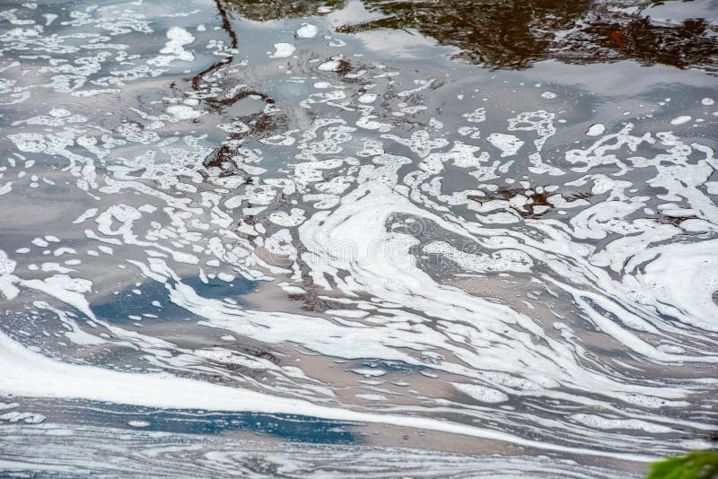 Abstract dirty water surface with white foam