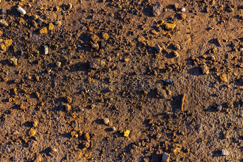 Abstract dry mud background with small rocks and selective focus stock image Abstract dry mud background with small rocks and selective focus stock image