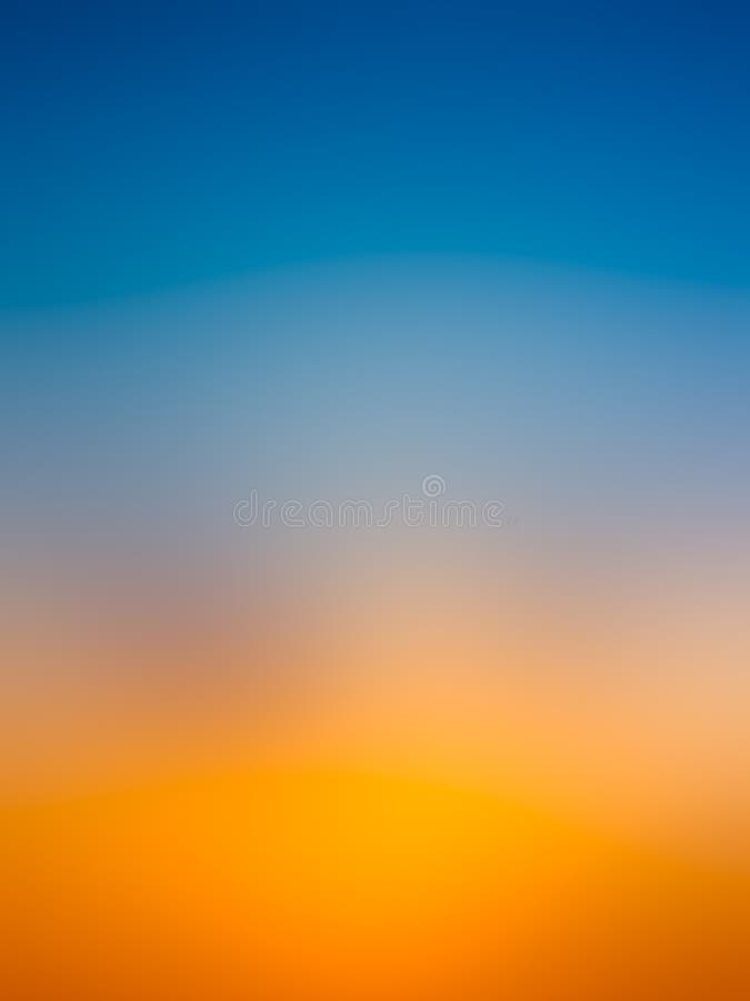 Abstract gradient sunrise in sky with blue and orange natural background