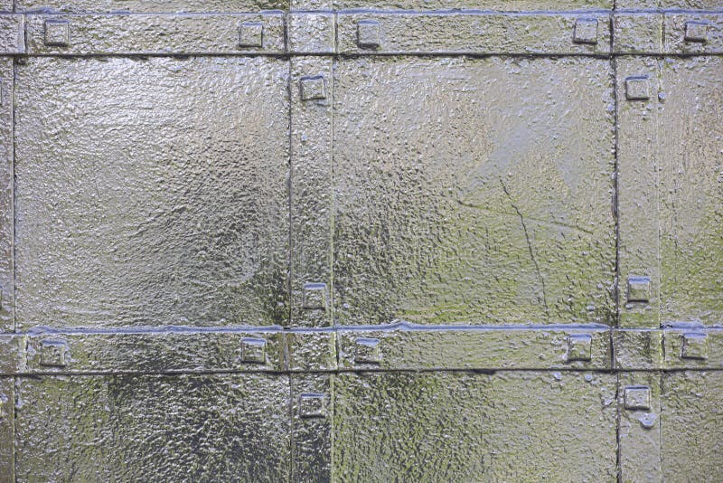 Abstract green industrial metal background texture with bolts and rivets. Old painted metal background Can be used as a background royalty free stock images Abstract green industrial metal background texture with bolts and rivets. Old painted metal background Can be used as a background royalty free stock images