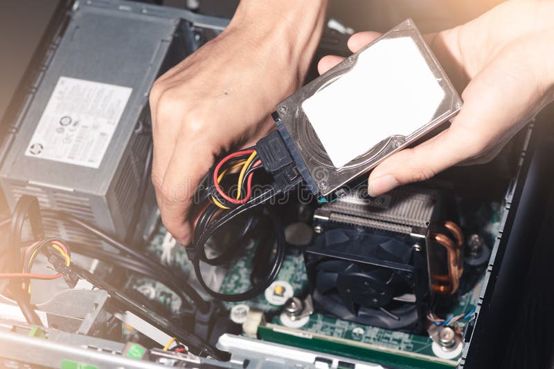 The abstract image of the technician put the Hard disk drive in the computer case stock image