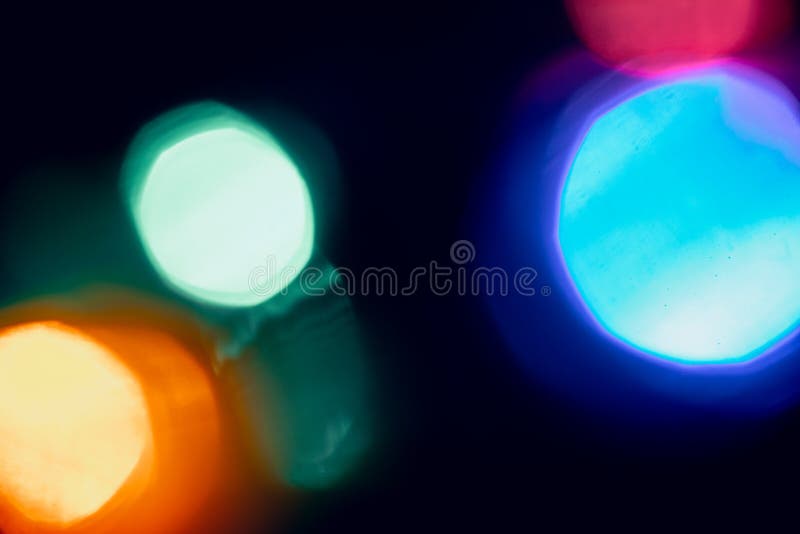 Abstract lens flare on black background. blue, red, orange, green defocused bokeh lights. glowing color burst. bokeh abstract