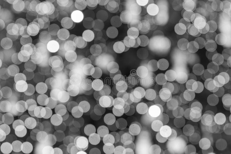 Abstract light bokeh as background. Defocused abstract christmas background. black and white bokeh