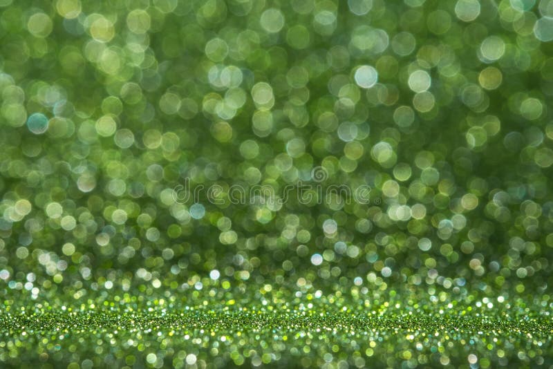 Green glitter surface with green light bokeh it can be used for background