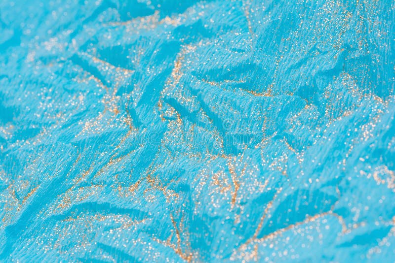 Abstract macro blue crumpled paper background with gold glitter stock photography