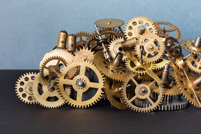 Abstract mechanical still life composition. Installation made up of bronze cogs gears of various kinds and antique. Bearings. Gray black background royalty free stock image Abstract mechanical still life composition. Installation made up of bronze cogs gears of various kinds and antique. Bearings. Gray black background royalty free stock image