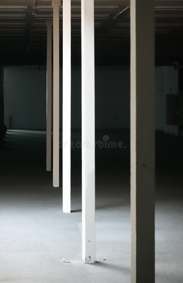 Abstract monochrome image of four rectangular columns in a semi-illuminated empty space stock images Abstract monochrome image of four rectangular columns in a semi-illuminated empty space stock images