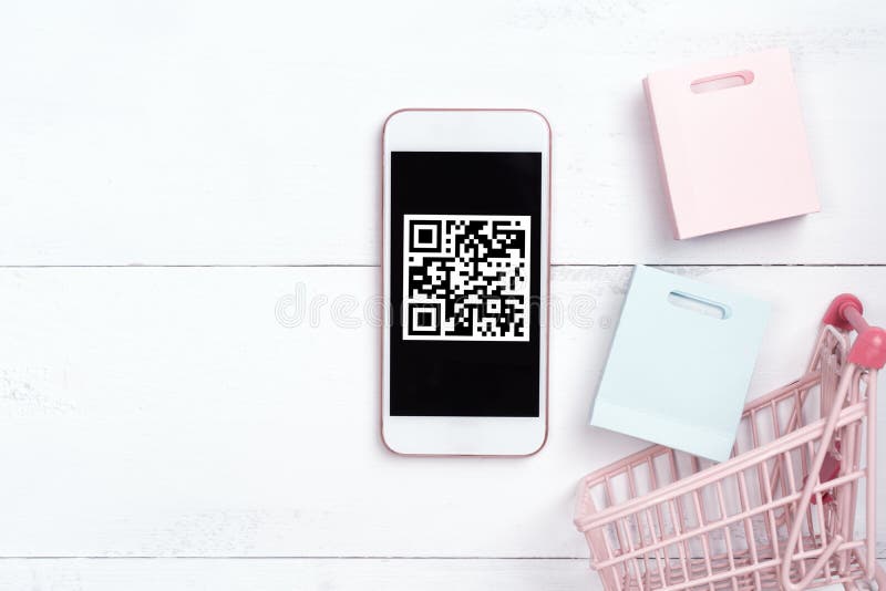 Abstract online shopping, mobile payment with QR code design concept element, colorful cart, paper bag on wooden table background royalty free stock image