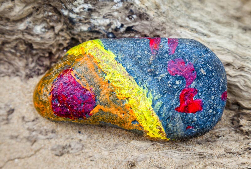 Abstract of a painted stone on a beach. royalty free stock image