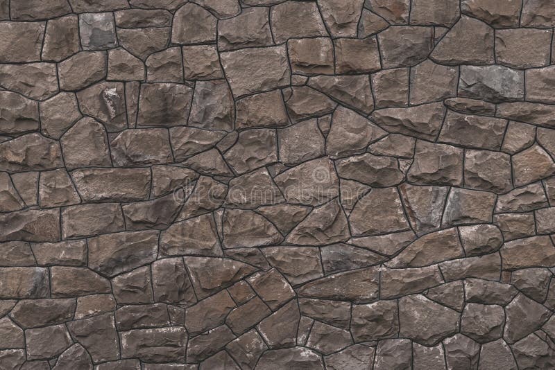Abstract pattern of light brown stone background. Rough surface, brick wall texture. Old stone wall. Cracked wall texture. Uneven royalty free stock photo
