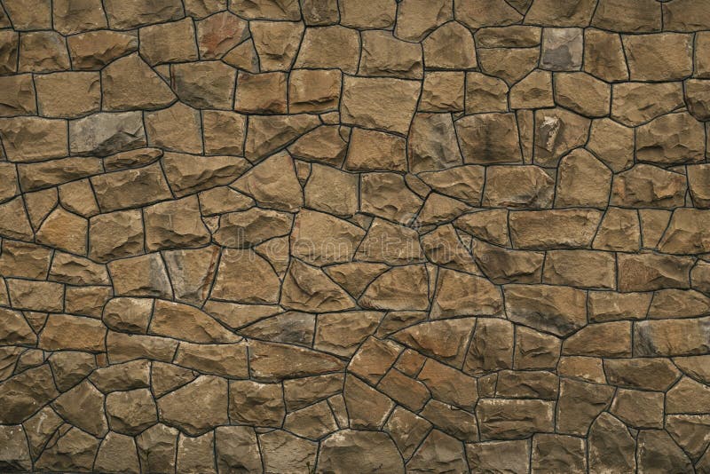 Abstract pattern of light brown stone background. Rough surface, brick wall texture. Old stone wall. Cracked wall texture. Uneven royalty free stock photo